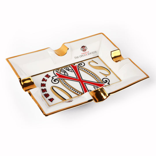 OpusX Society El Blanco white porcelain ashtray with red X and gold OXS emblem, gold rim and cigar rests