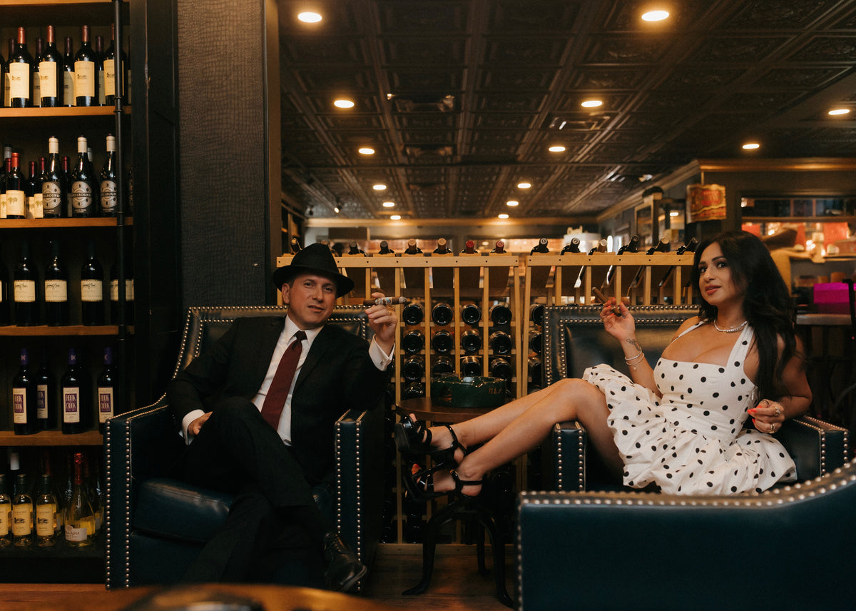 Guests relaxing in leather armchairs in the cigar lounge at Sun of a Gun Cigars & Spirits, Yuma, Arizona
