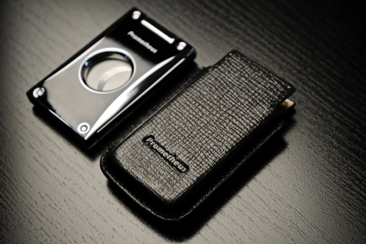 Prometheus leather case for Cutter H beside a black lacquer Cutter H