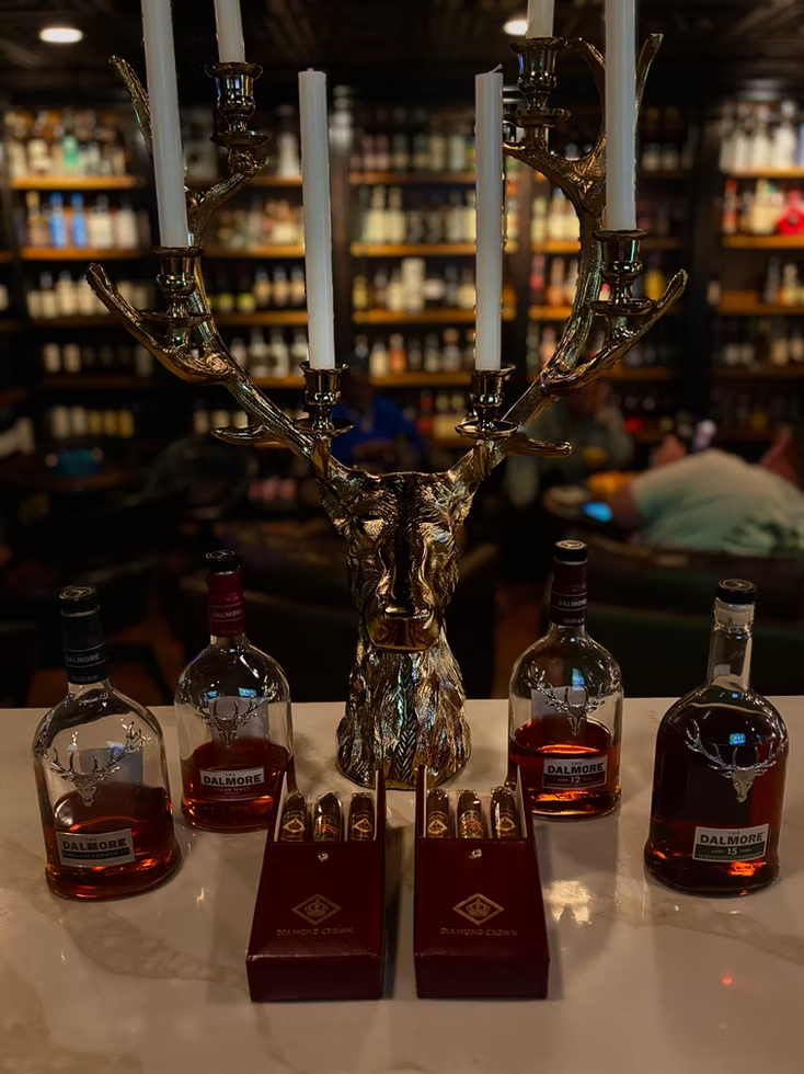Whisky bottles and boxed cigars on the bar at Sun of a Gun Cigars & Spirits, Yuma, Arizona