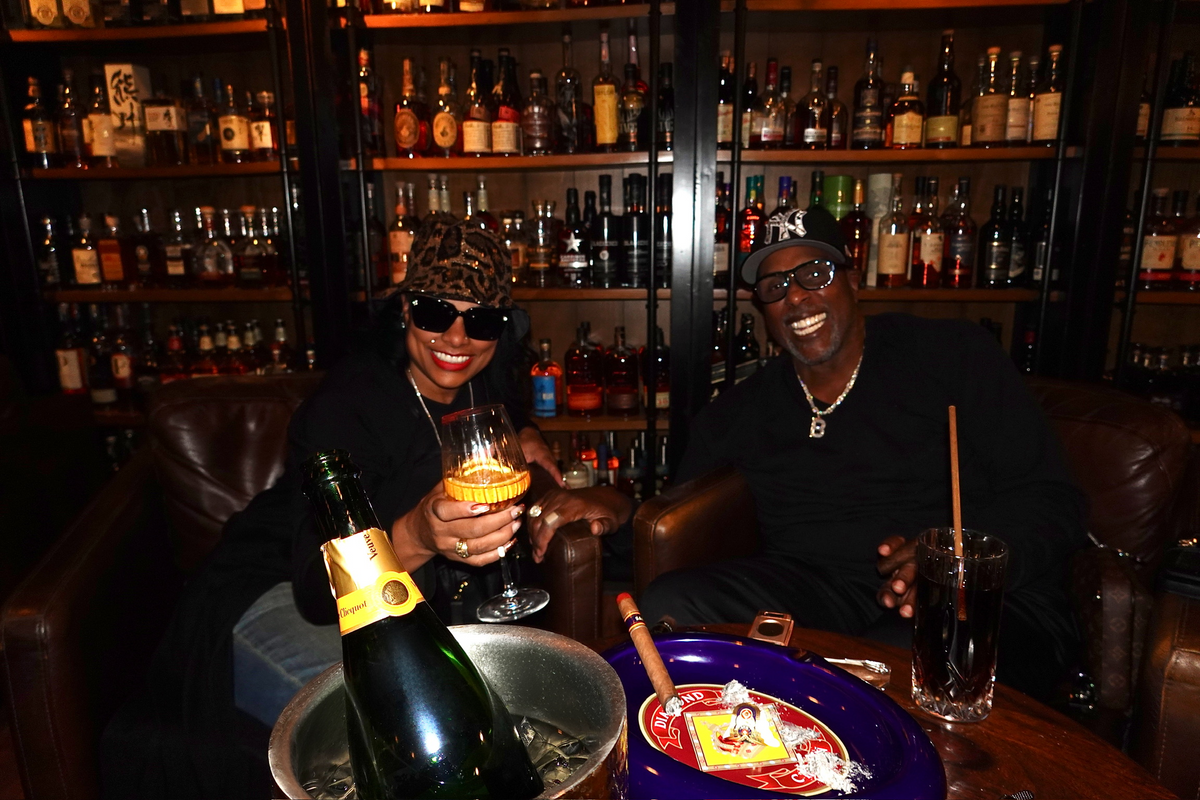 Guests in leather armchairs with Champagne on ice at Sun of a Gun Cigars & Spirits, Yuma, Arizona