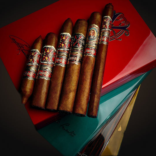 Fuente Fuente Opus6 Travel Humidor — 6 Rare Cigars & Book, several cigars resting on closed boxes — Sun of a Gun Cigars & Spirits, Yuma Arizona