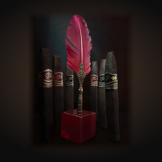 La Flor Dominicana Capitulo II, several cigars beside a quill pen display — Sun of a Gun Cigars & Spirits, Yuma Arizona