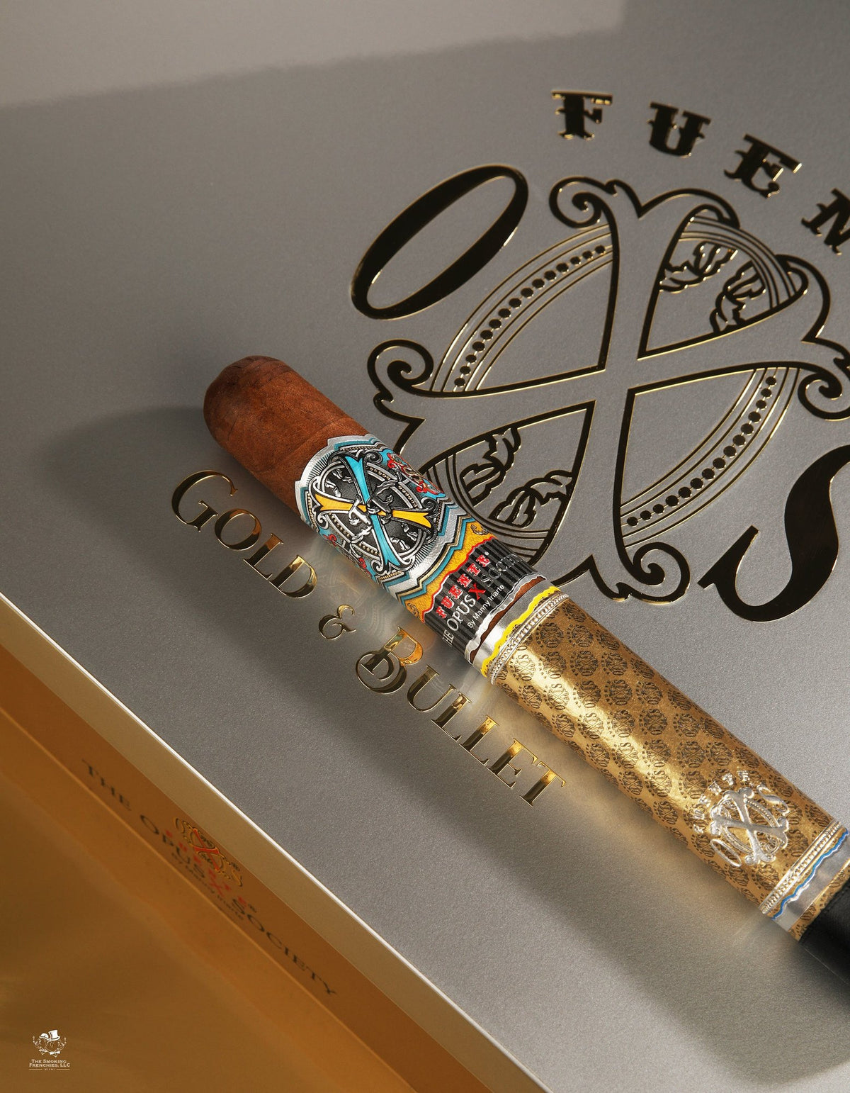 Fuente Fuente OpusX Gold & Bullet cigar with the OpusX Society band and gold sleeve, on the embossed Gold & Bullet box