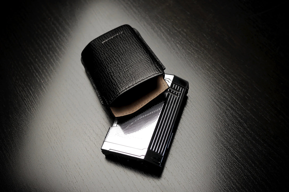 Prometheus leather case for Magma T with a Magma T lighter beside it
